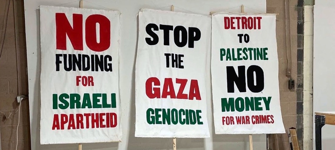 Banners with painted on slogans "no funding for Israeli apartheid", "stop the Gaza genocide" and "Detroit to Palestine no money for war crimes"